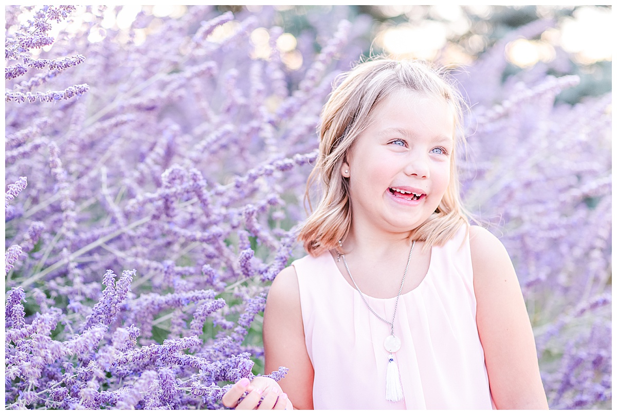 little girl in lilac bushes
